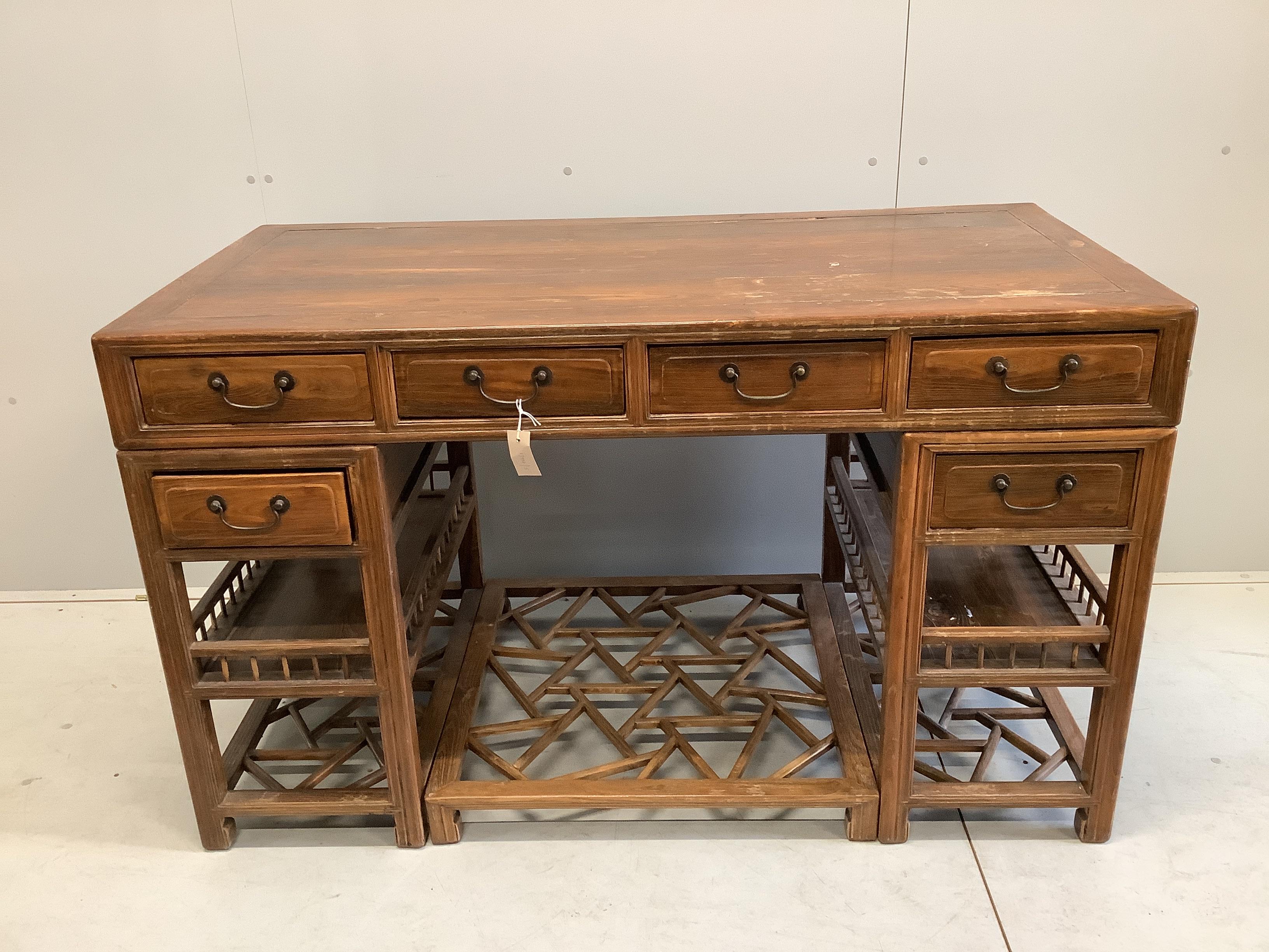 A Chinese elm pedestal desk, width 138cm, depth 68cm, height 83cm